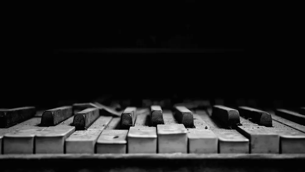 A war-torn piano keyboard. Downloaded from Wallhaven. Author and rights unknown - please get in touch for crediting, or if there's any issue.